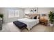 Spacious main bedroom featuring a wooden headboard, decorative pillows, and bedside tables with lamps for a cozy retreat at 2432 Hearth Dr, Odessa, FL 33556