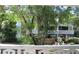 Balcony view with shade trees and a peek at the condo building at 2630 Pearce Dr # 208, Clearwater, FL 33764