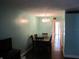 Dining room with a dark wooden table set and hardwood flooring, illuminated by a stylish chandelier at 2630 Pearce Dr # 208, Clearwater, FL 33764