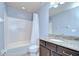 Bright bathroom featuring a shower-tub combo and granite countertop vanity at 2746 Birchcreek Dr, Wesley Chapel, FL 33544