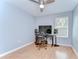 Bedroom featuring wood flooring, a ceiling fan, and a large window at 2746 Birchcreek Dr, Wesley Chapel, FL 33544
