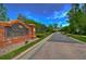 The Club at Seven Oaks entrance with brick signage and lush landscaping at 2746 Birchcreek Dr, Wesley Chapel, FL 33544