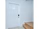 Bright entryway featuring a white door, hardwood stairs, tile flooring, and neutral wall paint at 2746 Birchcreek Dr, Wesley Chapel, FL 33544