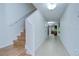 Spacious hallway showcasing tiled floors, stairway access, recessed lighting, and an open floor plan at 2746 Birchcreek Dr, Wesley Chapel, FL 33544