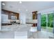 Beautiful kitchen with bar seating, stainless steel appliances, granite countertops, and a sliding glass door at 2746 Birchcreek Dr, Wesley Chapel, FL 33544