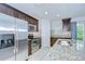 Gourmet kitchen featuring granite counters, stainless steel appliances, and stylish dark wood cabinetry at 2746 Birchcreek Dr, Wesley Chapel, FL 33544