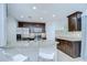 Spacious kitchen with a breakfast bar, stainless steel appliances, and dark wood cabinets at 2746 Birchcreek Dr, Wesley Chapel, FL 33544