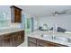 Bright kitchen features granite countertops, dark wood cabinets and stainless steel sink at 2746 Birchcreek Dr, Wesley Chapel, FL 33544