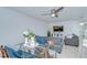 Cozy living area with modern glass table, entertainment center, and comfortable gray seating at 2746 Birchcreek Dr, Wesley Chapel, FL 33544