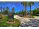 Tennis court rules sign with palm trees, bushes, and well maintained tennis courts at 2746 Birchcreek Dr, Wesley Chapel, FL 33544