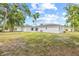 The expansive backyard showcases the house with its sliding glass doors and attached dwelling at 2901 Forestwood Dr, Seffner, FL 33584