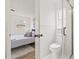 Modern bathroom with white marble tile and glass-enclosed shower next to a bedroom at 2901 Forestwood Dr, Seffner, FL 33584