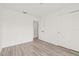 Spacious bedroom with wood-look floors, large closet, and bright doorway at 2901 Forestwood Dr, Seffner, FL 33584