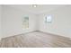 Bright, empty bedroom with wood-look floors and natural light from two windows at 2901 Forestwood Dr, Seffner, FL 33584
