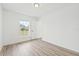 Clean bedroom with wood-look floors, closet, and natural light from the window at 2901 Forestwood Dr, Seffner, FL 33584
