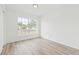 Sunny bedroom with wood-look floors and a bright window at 2901 Forestwood Dr, Seffner, FL 33584