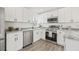 Bright kitchen featuring white cabinets, stainless steel appliances, and granite countertops at 2901 Forestwood Dr, Seffner, FL 33584