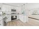 Open kitchen design featuring white cabinets, granite countertops, and a center island at 2901 Forestwood Dr, Seffner, FL 33584