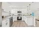 Bright kitchen features white cabinetry, granite countertops, and stainless steel appliances at 2901 Forestwood Dr, Seffner, FL 33584