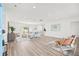 Bright living room with wood-look floors, neutral decor, and sliding glass doors for easy outdoor access at 2901 Forestwood Dr, Seffner, FL 33584