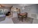 Cozy dining area with stylish chandelier and seamless flow to the living room and kitchen at 2952 Macalpin N Dr, Palm Harbor, FL 34684