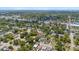 An aerial view of the neighborhood including homes, businesses, and tree lined streets at 3215 E Powhatan Ave, Tampa, FL 33610