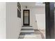 Rear entry view of home, featuring smooth white facade and matching stoop at 3215 E Powhatan Ave, Tampa, FL 33610