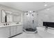 Modern bathroom featuring a standalone tub and tiled shower with glass door at 3215 E Powhatan Ave, Tampa, FL 33610