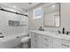 Bathroom featuring double sinks, marble countertop, and modern tiled shower with glass door at 3215 E Powhatan Ave, Tampa, FL 33610