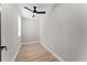 Cozy bedroom features wood floors, a ceiling fan and natural light from a window at 3215 E Powhatan Ave, Tampa, FL 33610