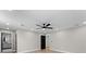 A bright bedroom with wood flooring, ceiling fan, and access to the bathroom at 3215 E Powhatan Ave, Tampa, FL 33610