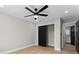 This bedroom features a modern ceiling fan, wood floors, and black closet doors at 3215 E Powhatan Ave, Tampa, FL 33610
