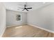Bedroom featuring wood flooring, recessed lighting, ceiling fan, and natural light at 3215 E Powhatan Ave, Tampa, FL 33610