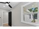Bedroom with wood floors, modern ceiling fan and a view to the exterior at 3215 E Powhatan Ave, Tampa, FL 33610