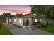 Charming renovated home boasting a freshly painted exterior, manicured landscaping, and welcoming front porch at 3215 E Powhatan Ave, Tampa, FL 33610