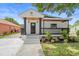 A beautifully renovated home with black and white color scheme, a cozy porch, and new landscaping at 3215 E Powhatan Ave, Tampa, FL 33610