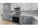 Modern kitchen showcases gray cabinets, quartz countertops, stainless steel appliances, and stylish design at 3215 E Powhatan Ave, Tampa, FL 33610