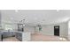 Bright open-concept kitchen features gray cabinets, stainless appliances, and a large center island at 3215 E Powhatan Ave, Tampa, FL 33610