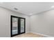 The room features natural light, and access to the backyard through double glass doors at 3215 E Powhatan Ave, Tampa, FL 33610