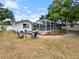 Spacious backyard featuring a screened pool, fire pit, shed, and fenced in yard at 3508 Yale Cir, Riverview, FL 33578