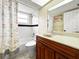 Bathroom featuring vanity with granite countertop, tub with shower, and flamingo decor at 3508 Yale Cir, Riverview, FL 33578