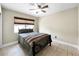 Comfortable bedroom with a decorative window shade, ceiling fan and tile flooring at 3508 Yale Cir, Riverview, FL 33578