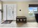 Bright entryway with tile flooring, decorative rug, ample natural light, and bench at 3508 Yale Cir, Riverview, FL 33578