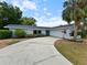 Charming single-story home featuring a curved driveway and a beautiful blue front door at 3508 Yale Cir, Riverview, FL 33578