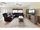 Comfortable living room featuring neutral walls, tile floors, ceiling fan, and large leather sectional at 3508 Yale Cir, Riverview, FL 33578
