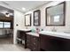 Spacious main bathroom with double sink vanity and well-lit mirrors at 3508 Yale Cir, Riverview, FL 33578