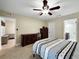 Bright bedroom featuring tile flooring, ceiling fan, and access to the en-suite bathroom at 3508 Yale Cir, Riverview, FL 33578