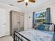 Charming bedroom with a black metal bed, wood armoire, and bright natural light at 37 W Boyer St, Tarpon Springs, FL 34689