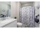 Bathroom featuring a marble countertop vanity, brushed nickel fixtures, and a shower with a marble curtain at 3727 Wild Blossom Pl, Parrish, FL 34219