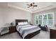 Comfortable bedroom featuring tray ceilings, plantation shutters and neutral paint at 3727 Wild Blossom Pl, Parrish, FL 34219